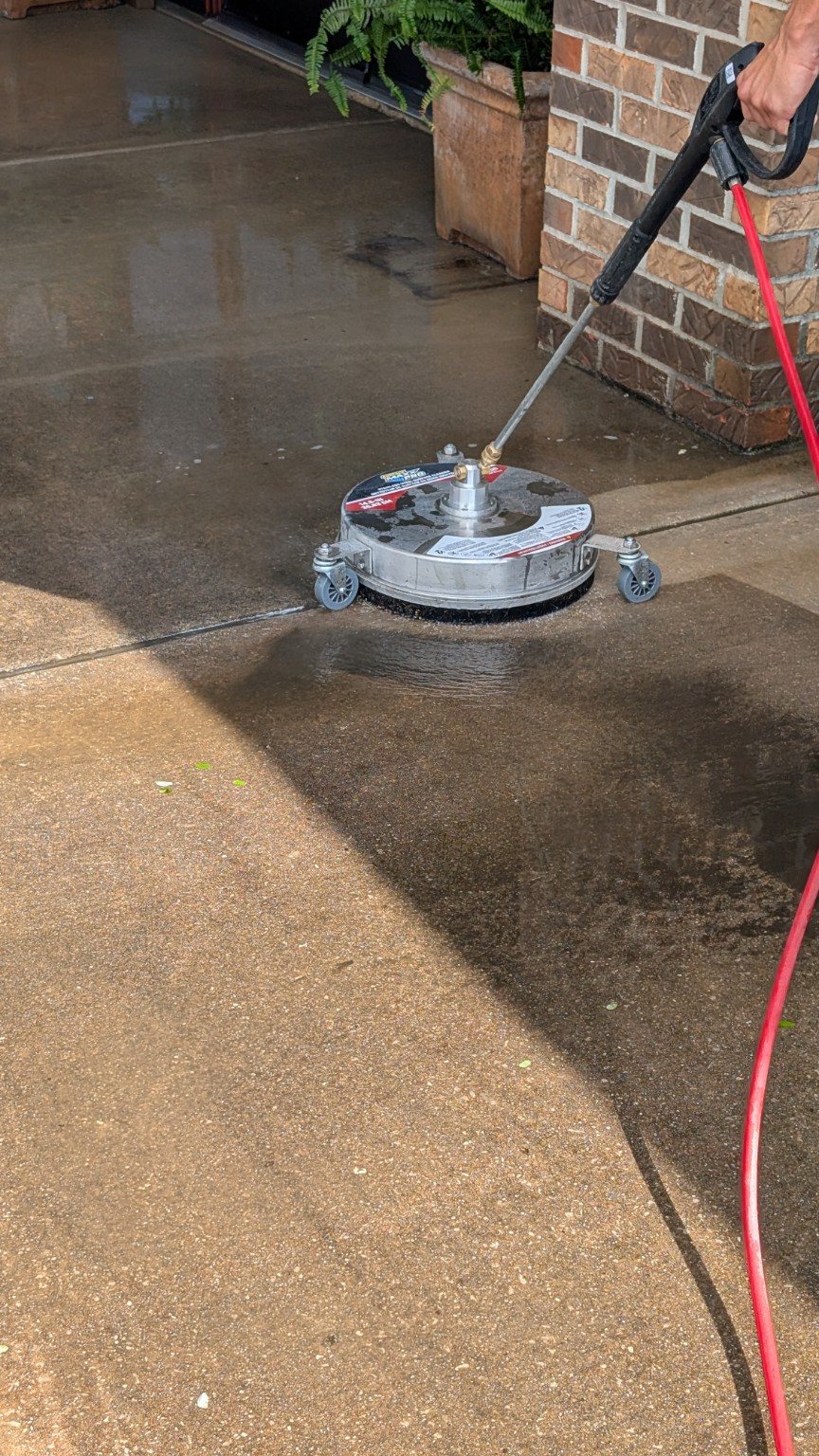Surface cleaner washing concrete at a commercial entrance